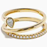 The 14K Yellow Gold Diamond Wrap Ring features two intertwined bands—one with a pear-shaped clear gemstone, the other accented by sparkling round diamonds along the top half—for an elegant, dazzling look.
