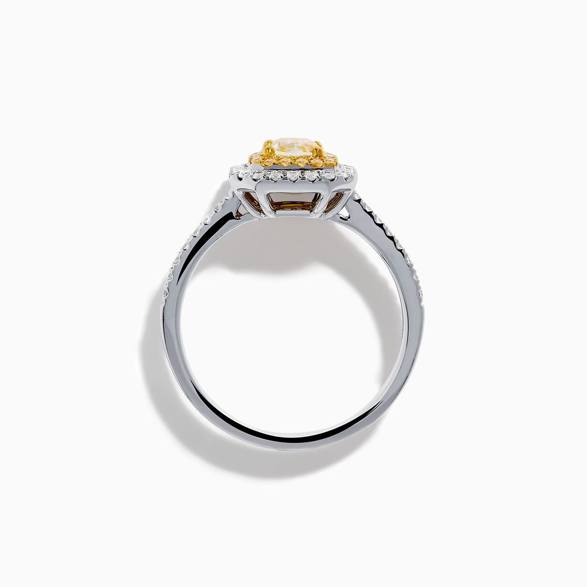 The Canare 18K Two Tone Gold White and Yellow Diamond Ring features a large rectangular yellow gemstone, double halo of white diamonds, and diamond accents on the elegant band.