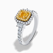The Canare 18K Two Tone Gold White & Yellow Diamond Ring showcases a rectangular yellow gemstone, double halo of white and yellow diamonds, and diamond-accented band—a striking statement piece.