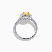 The Canare 18K Two Tone Gold White & Yellow Diamond Ring features a central oval yellow gemstone, accented by a halo of white diamonds and additional diamonds set along the band.