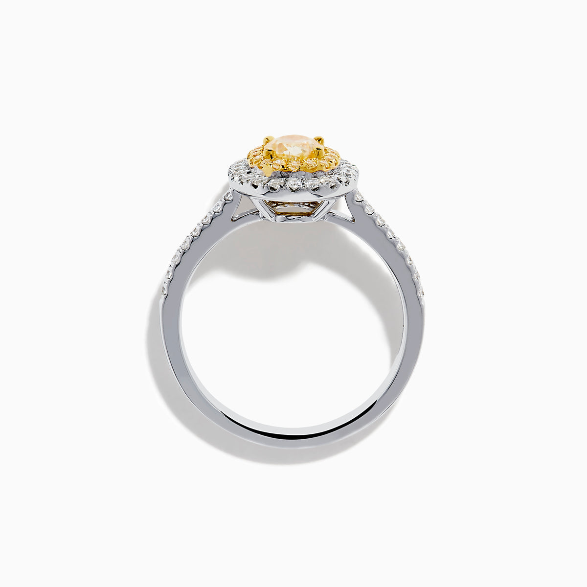 The Canare 18K Two Tone Gold White & Yellow Diamond Ring features a central oval yellow gemstone, accented by a halo of white diamonds and additional diamonds set along the band.