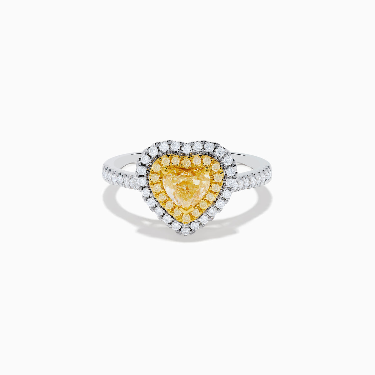 The Canare 18K Two Tone Gold White & Yellow Diamond Heart Ring features a heart-shaped yellow gemstone center with a double halo of yellow and clear diamonds, inspired by elegant Canare designs.