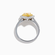 The Canare 18K Two Tone Gold White & Yellow Diamond Heart Ring features a heart-shaped yellow gemstone center with a double halo of yellow and clear diamonds, inspired by elegant Canare designs.