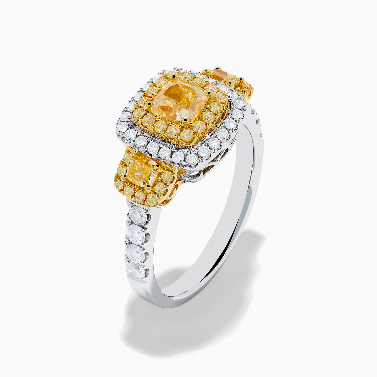The Canare 18K Two Tone Gold White and Yellow Diamond Ring features a large rectangular yellow diamond center, encircled by rows of yellow and white diamonds, with side yellow diamonds bordered by sparkling white stones.
