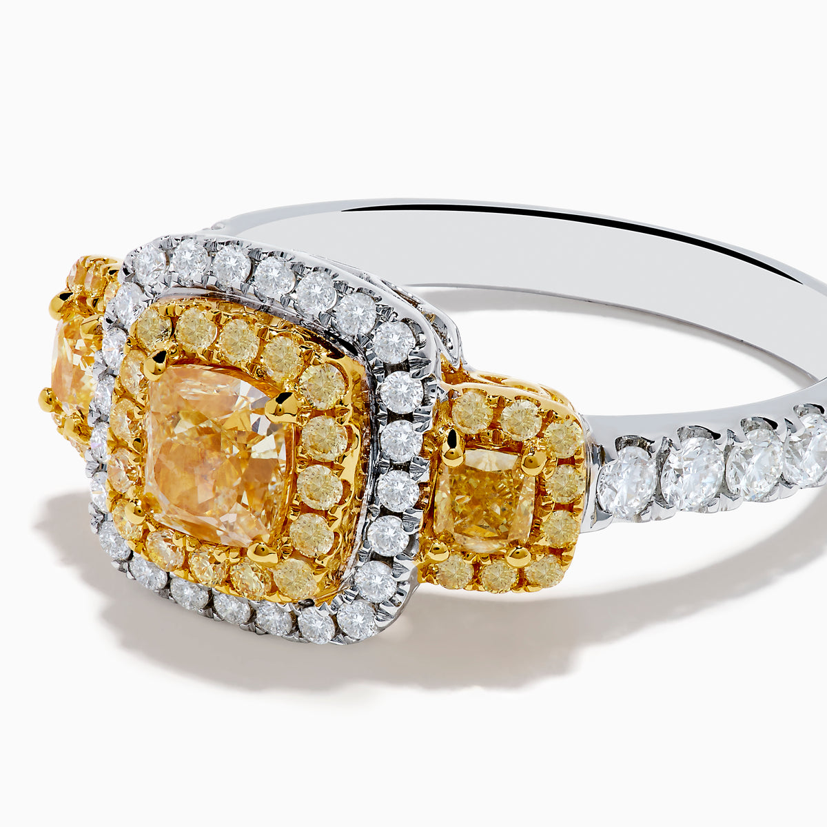 The Canare 18K Two Tone Gold White and Yellow Diamond Ring features a large rectangular yellow diamond center, encircled by rows of yellow and white diamonds, with side yellow diamonds bordered by sparkling white stones.