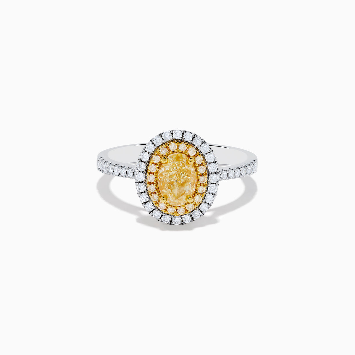 A close-up of the Canare 18K Two Tone Gold White & Yellow Diamond Ring, highlighting its oval yellow center stone encircled by two halos of white diamonds and additional diamonds set along the elegant silver band.