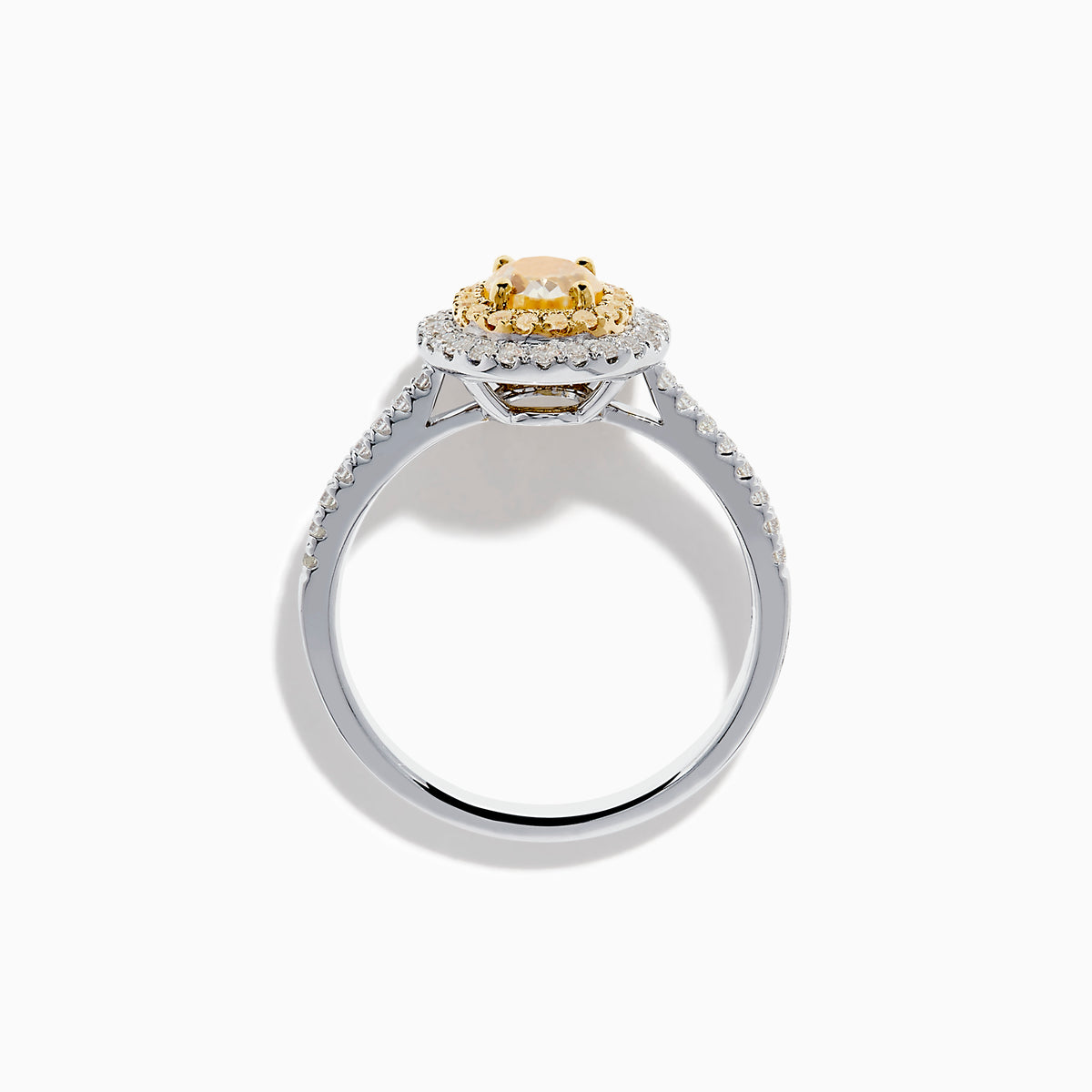 A close-up of the Canare 18K Two Tone Gold White & Yellow Diamond Ring, highlighting its oval yellow center stone encircled by two halos of white diamonds and additional diamonds set along the elegant silver band.