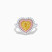 The Trio 18K Tri Color Gold White, Pink, and Yellow Diamond Heart Ring features a yellow diamond center, surrounded by pink and white diamonds on an 18K gold band for a luxurious finish.