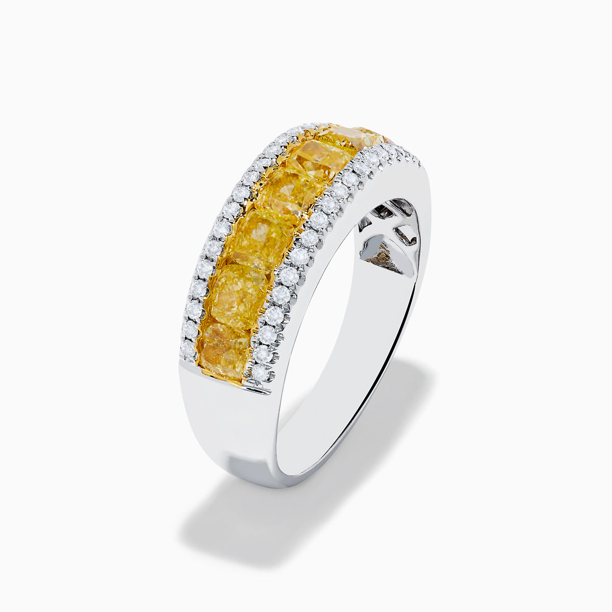 The Canare 18K Two Tone Gold White and Yellow Diamond Band Ring features a central row of yellow diamonds bordered by two rows of white diamonds, beautifully displayed on a white background.