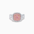 The 18K Two Tone Gold White and Pink Diamond Ring features a cushion-shaped cluster of pink diamonds at the center, encircled by a double halo of white diamonds, with more diamonds set along the band.