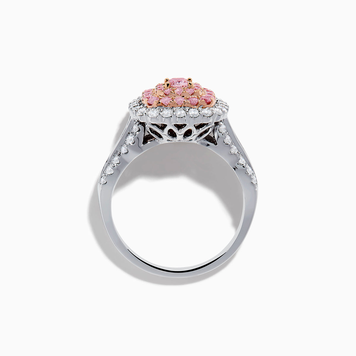 The 18K Two Tone Gold White and Pink Diamond Ring features a cushion-shaped cluster of pink diamonds at the center, encircled by a double halo of white diamonds, with more diamonds set along the band.