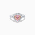 The 18K Two Tone Gold White and Pink Diamond Heart Ring features a heart design with pink diamonds at the center, white diamonds encircling the heart, and additional diamonds along the band for extra sparkle.