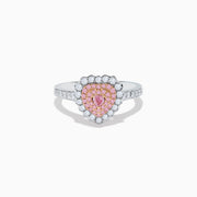 The 18K Two Tone Gold White and Pink Diamond Heart Ring features a heart design with pink diamonds at the center, white diamonds encircling the heart, and additional diamonds along the band for extra sparkle.