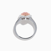 The 18K Two Tone Gold White and Pink Diamond Heart Ring features a heart design with pink diamonds at the center, white diamonds encircling the heart, and additional diamonds along the band for extra sparkle.