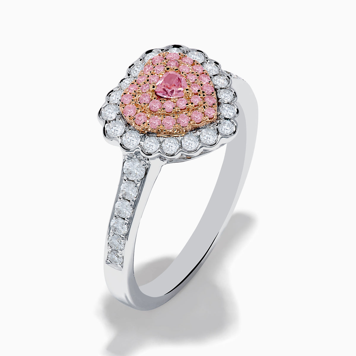 The 18K Two Tone Gold White and Pink Diamond Heart Ring features a heart design with pink diamonds at the center, white diamonds encircling the heart, and additional diamonds along the band for extra sparkle.