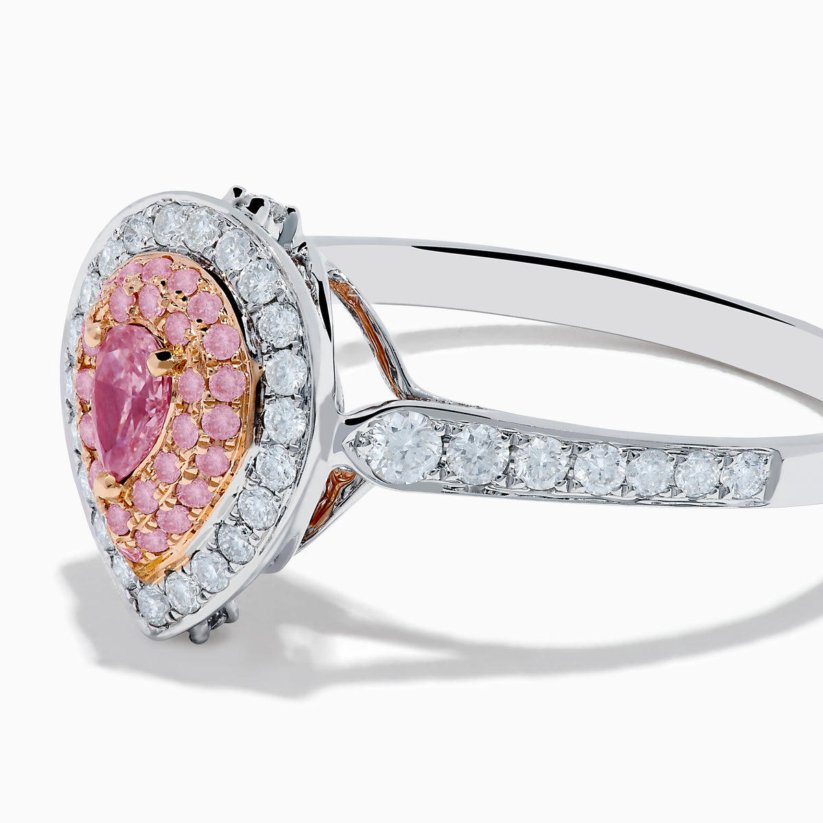 The 18K Two Tone Gold White and Pink Diamond Ring features a teardrop-shaped center with a pink gemstone, surrounded by pink and white stones, set on a band adorned with sparkling white diamonds.