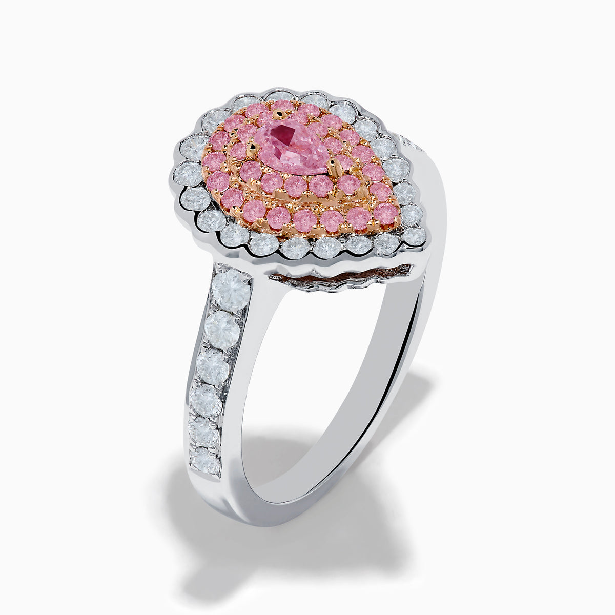 The 18K Two Tone Gold White and Pink Diamond Ring features a teardrop-shaped pink center stone, two rows of pink diamonds, an outer row of white diamonds, and a diamond-adorned band for an elegant look.