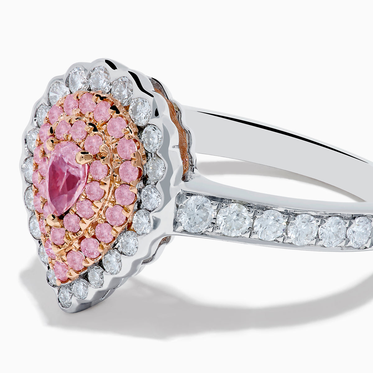 The 18K Two Tone Gold White and Pink Diamond Ring features a teardrop-shaped pink center stone, two rows of pink diamonds, an outer row of white diamonds, and a diamond-adorned band for an elegant look.