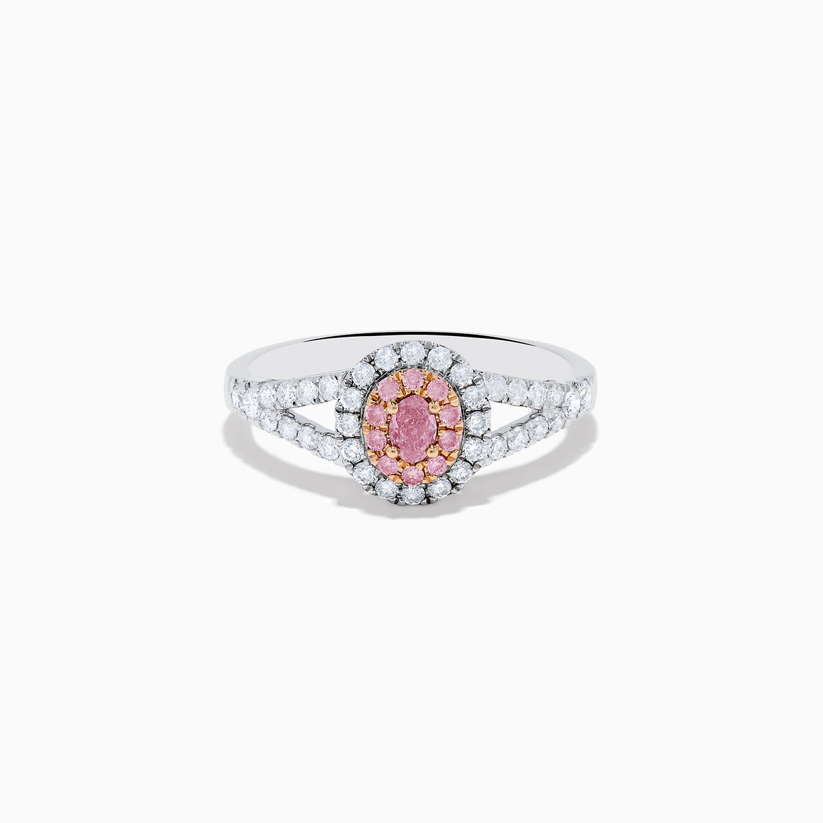 The 18K Two Tone Gold White and Pink Diamond Ring features an oval pink center gemstone, a halo of white and pink stones, and additional white stones set along the split band.