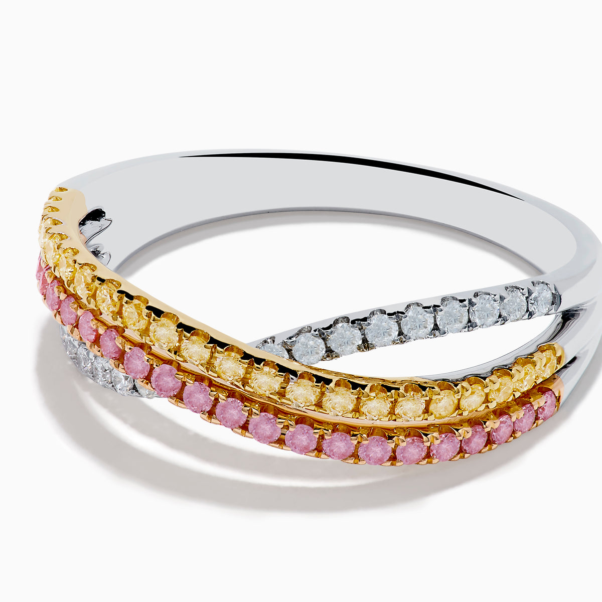 The Trio 18K Gold Pink, Yellow, and White Diamond Criss Cross Ring showcases three intertwined rows with pink, yellow, and white diamonds and elegant details, all set against a white background.