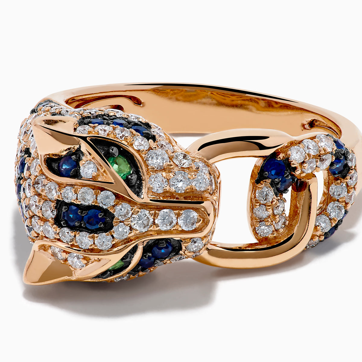 The Signature 14K Rose Gold Diamond, Sapphire and Emerald Ring features a panther’s head encrusted with white diamonds, blue sapphires, and green emeralds, with the panther biting a ring in its mouth.