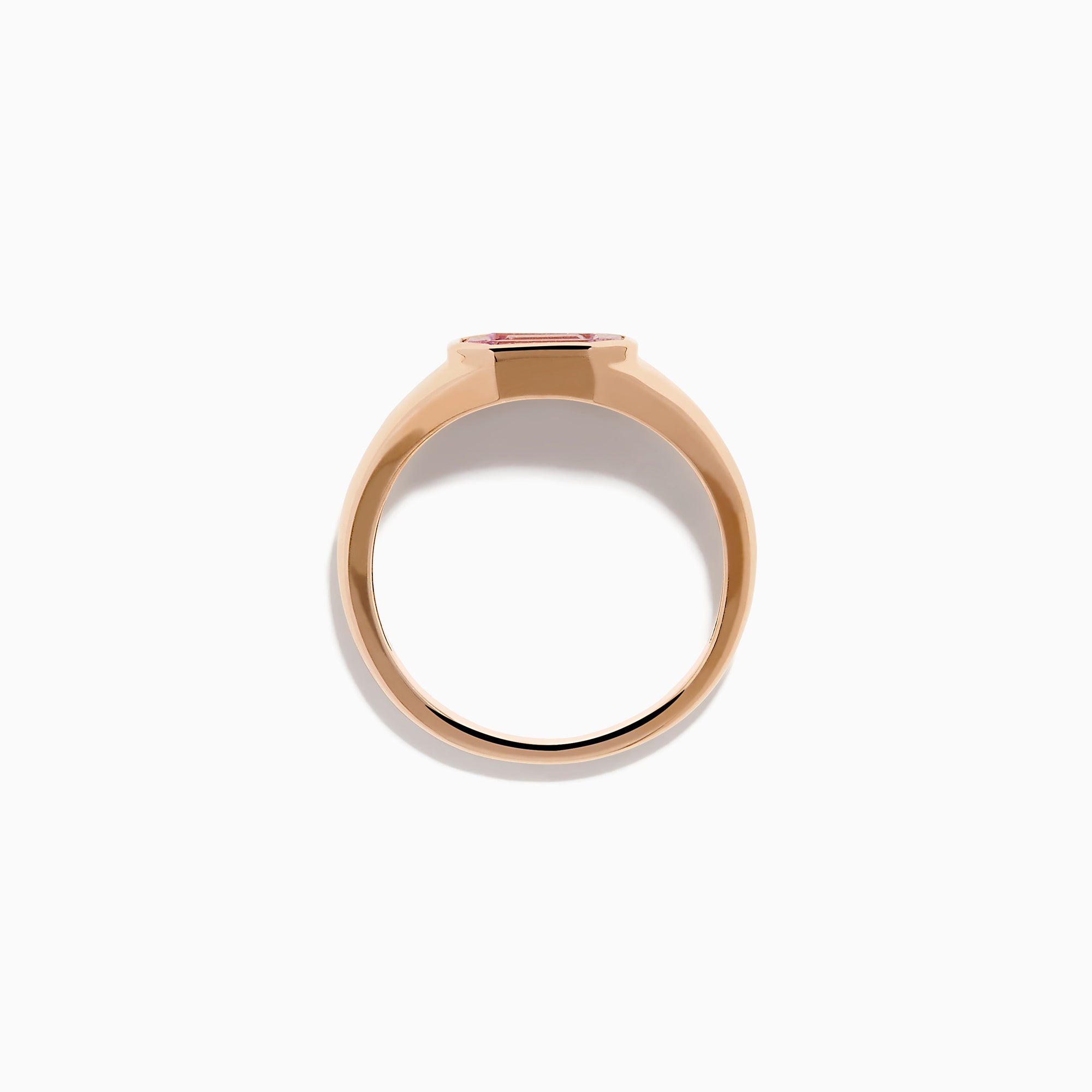 The 14K Rose Gold Bezel Set Pink Sapphire Ring showcases an emerald-cut pink sapphire in a bezel setting, presented on a white background.