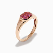The 14K Rose Gold Bezel Set Pink Sapphire Ring showcases an emerald-cut pink sapphire in a bezel setting, presented on a white background.