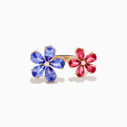 The 14K Rose Gold Tanzanite, Tourmaline and Diamond Floral Ring features two flower designs with tanzanite blue and pink tourmaline petals, each centered by a sparkling diamond, all set against a white background.