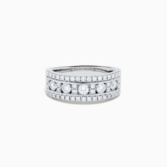 The 14K White Gold Channel Set Diamond Wide Band Ring features three rows of round diamonds, with five larger channel-set stones in the center and smaller diamonds on either side, creating an elegant, eye-catching look.