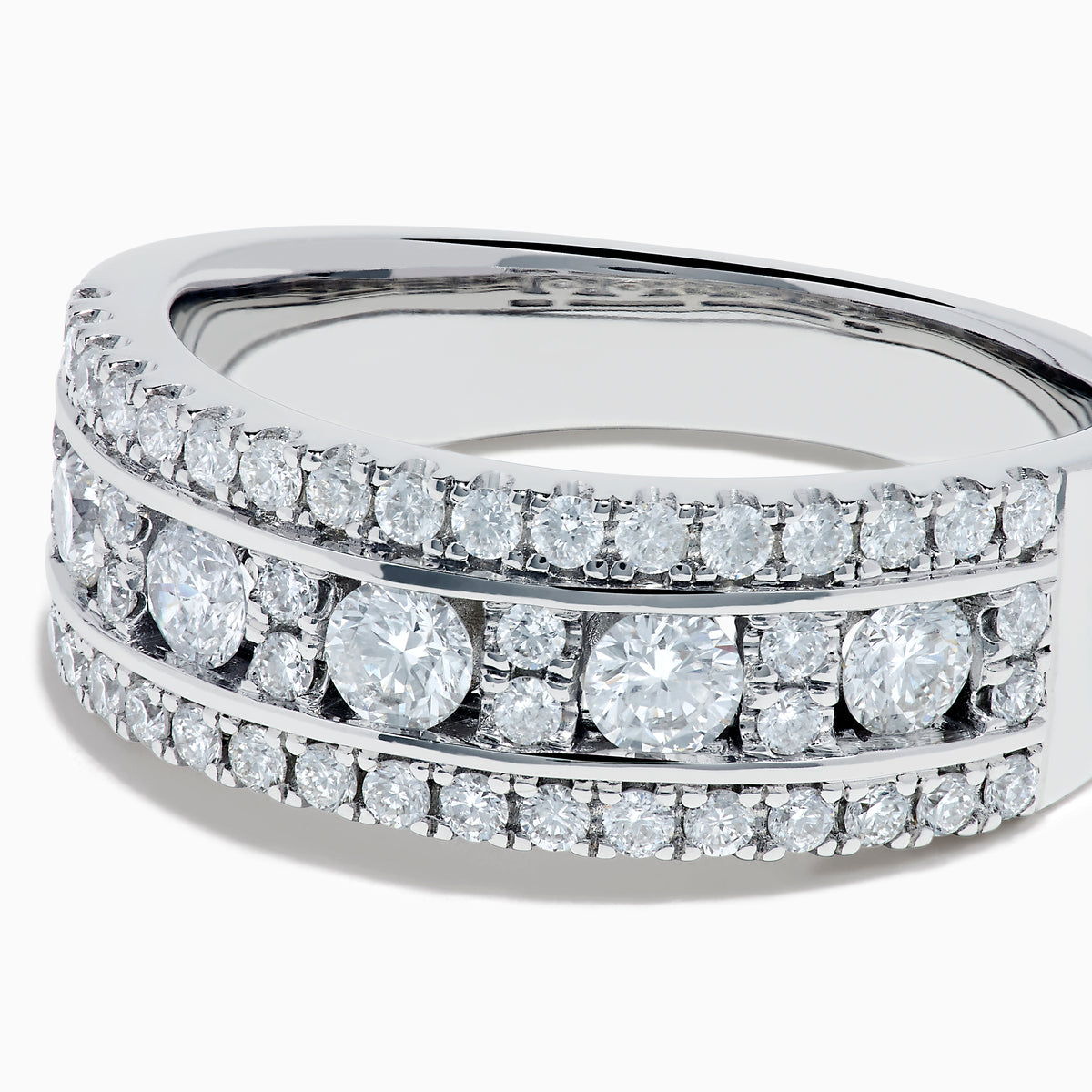 The 14K White Gold Channel Set Diamond Wide Band Ring features three rows of round diamonds, with five larger channel-set stones in the center and smaller diamonds on either side, creating an elegant, eye-catching look.