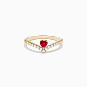 The 14K Yellow Gold Ruby Heart and Diamond Contoured Ring features a V-shaped band set with white diamonds and a vivid ruby heart at its center.