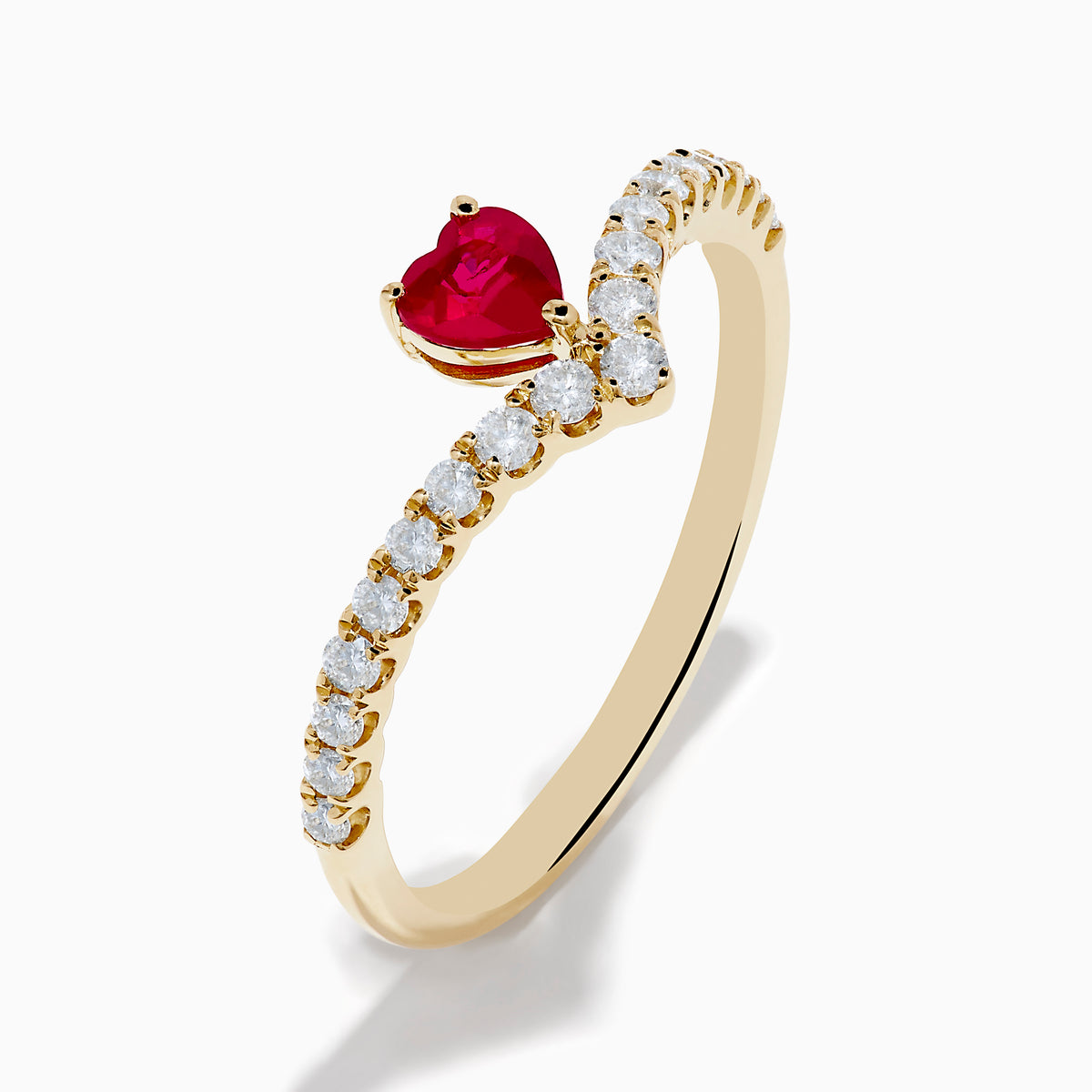 The 14K Yellow Gold Ruby Heart and Diamond Contoured Ring features a V-shaped band set with white diamonds and a vivid ruby heart at its center.