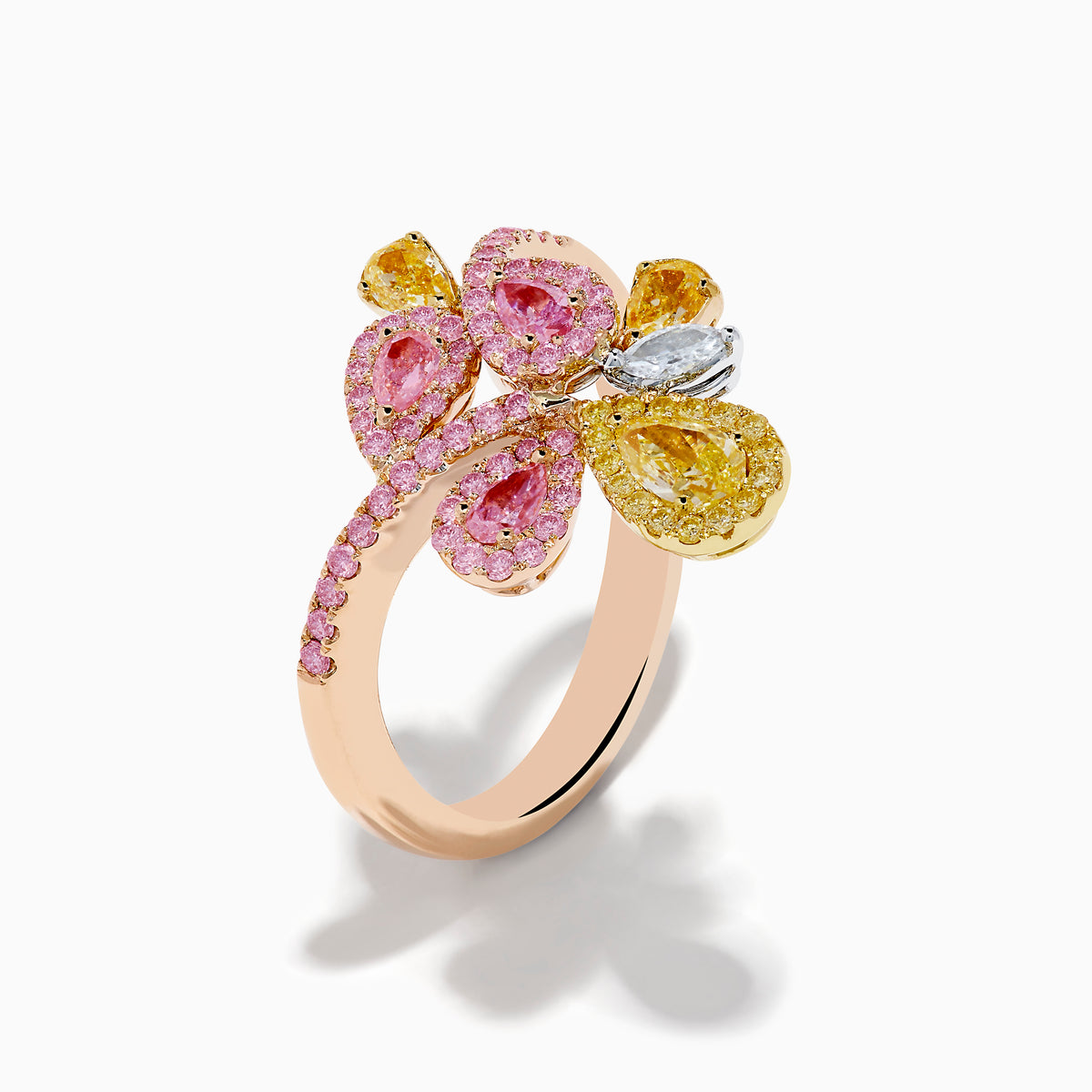 The Trio 18K Three Tone Gold Multi Color Diamond Bouquet Ring showcases overlapping loops with pink, yellow, and white diamonds in a delicate floral-inspired bouquet design.