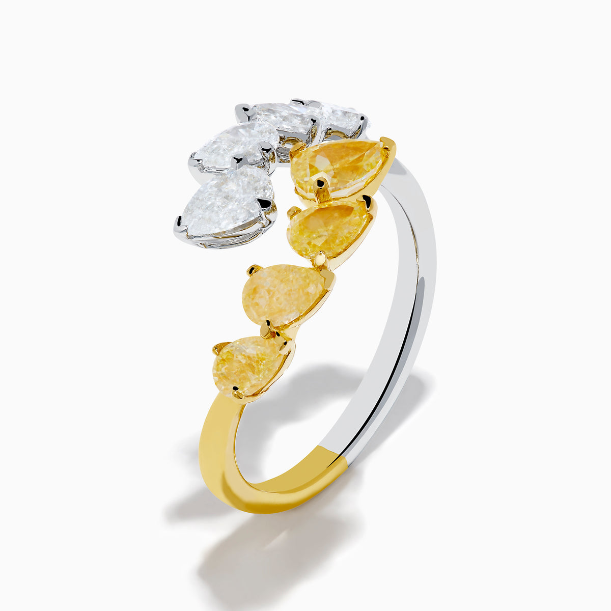 The Canare 18K Two Tone Gold White & Yellow Diamond Bypass Ring showcases three yellow pear-shaped diamonds on one side and three white pears on the other, displayed against a simple white background.