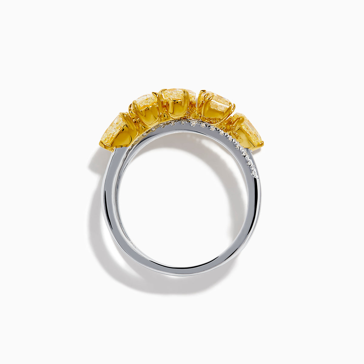 The 18K Two Tone White & Yellow Diamond Criss Cross Ring features a split silver band with five yellow pear-shaped stones on one side and white diamonds on the other, shown against a white background.