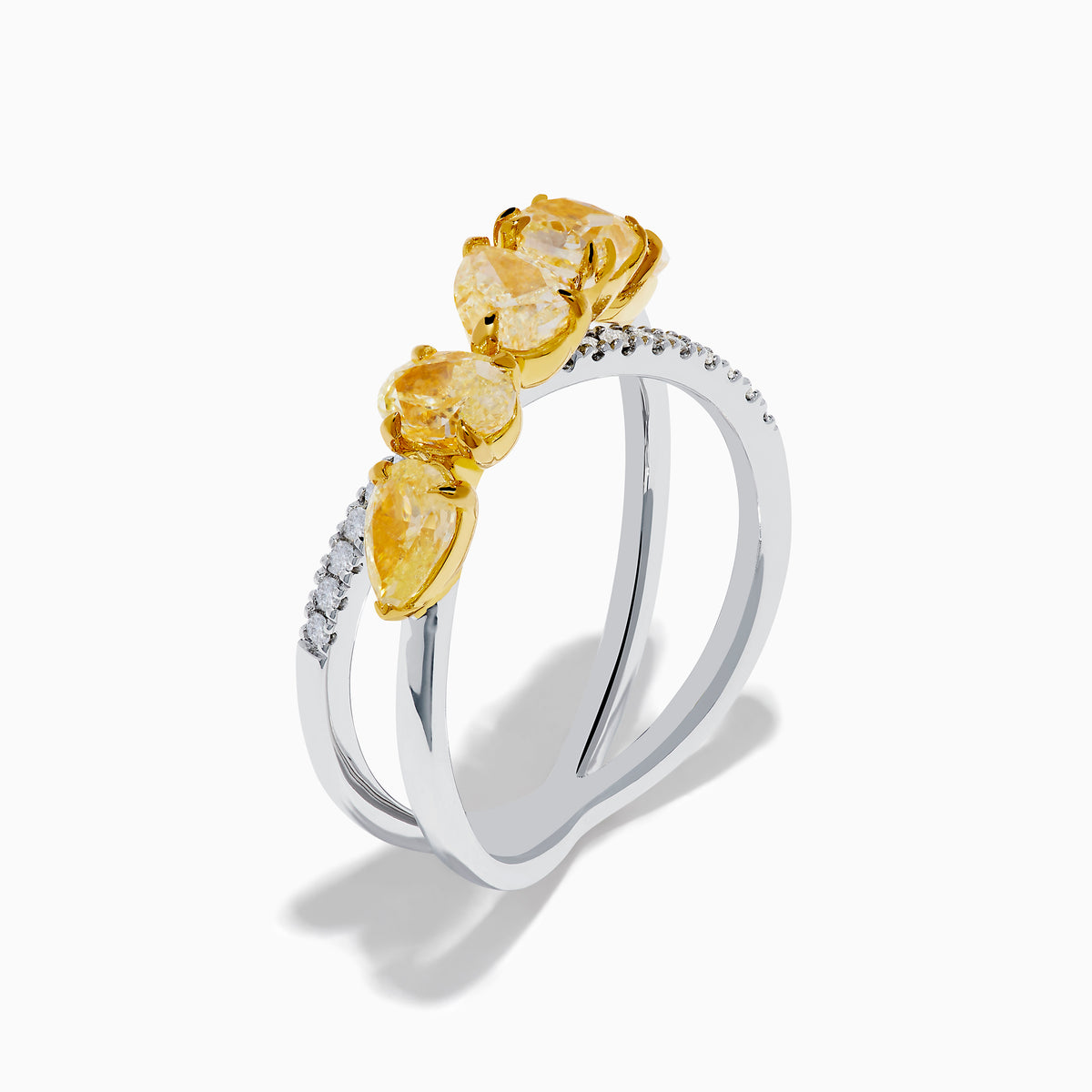 The 18K Two Tone White & Yellow Diamond Criss Cross Ring features a split silver band with five yellow pear-shaped stones on one side and white diamonds on the other, shown against a white background.