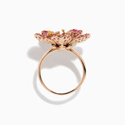 The Nature 14K Rose Gold Pink Sapphire and Diamond Flower Ring features a floral design with five petals, small pink and red gemstones, a central oval pink sapphire, and shimmering rose gold outlining for added sparkle.