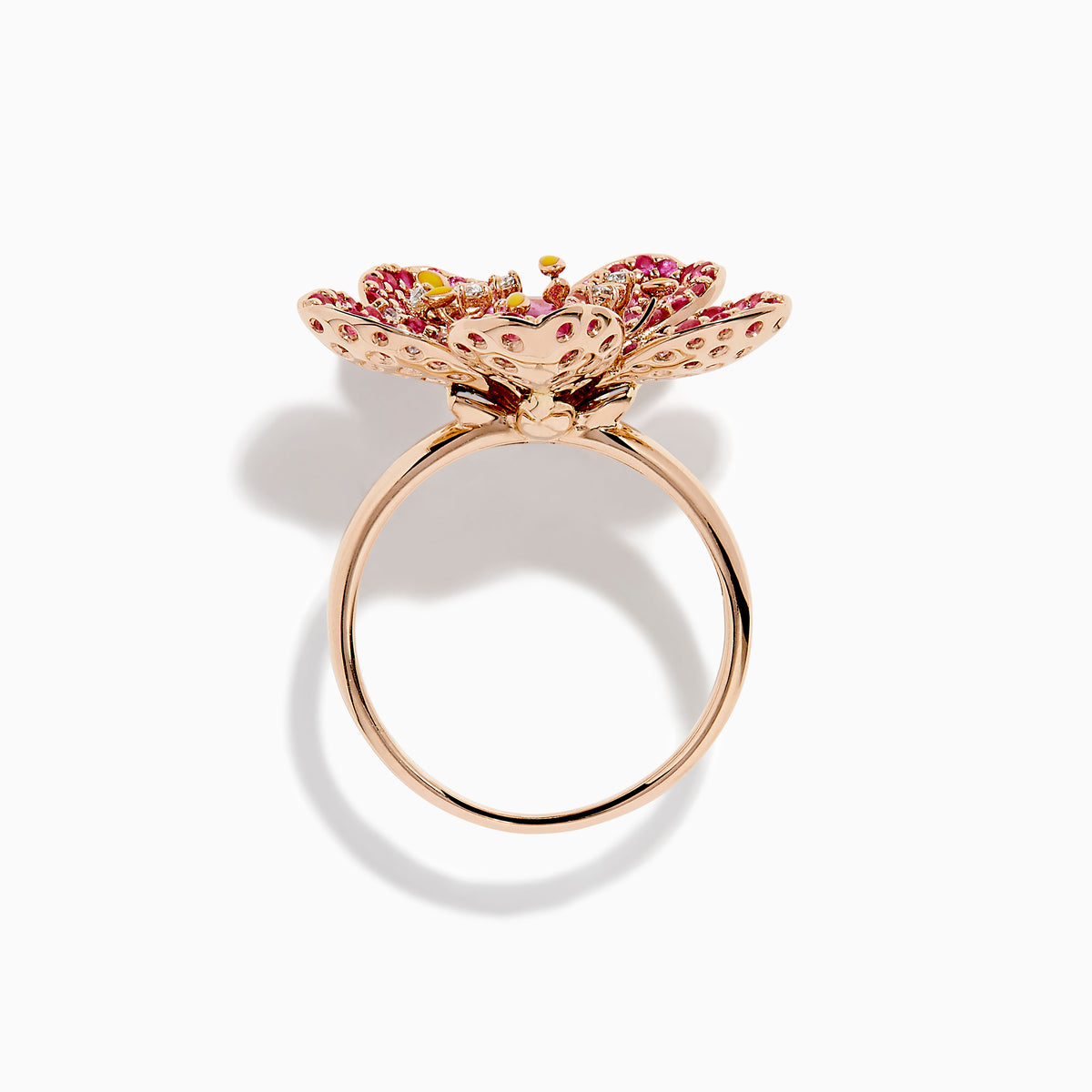 The Nature 14K Rose Gold Pink Sapphire and Diamond Flower Ring features a floral design with five petals, small pink and red gemstones, a central oval pink sapphire, and shimmering rose gold outlining for added sparkle.