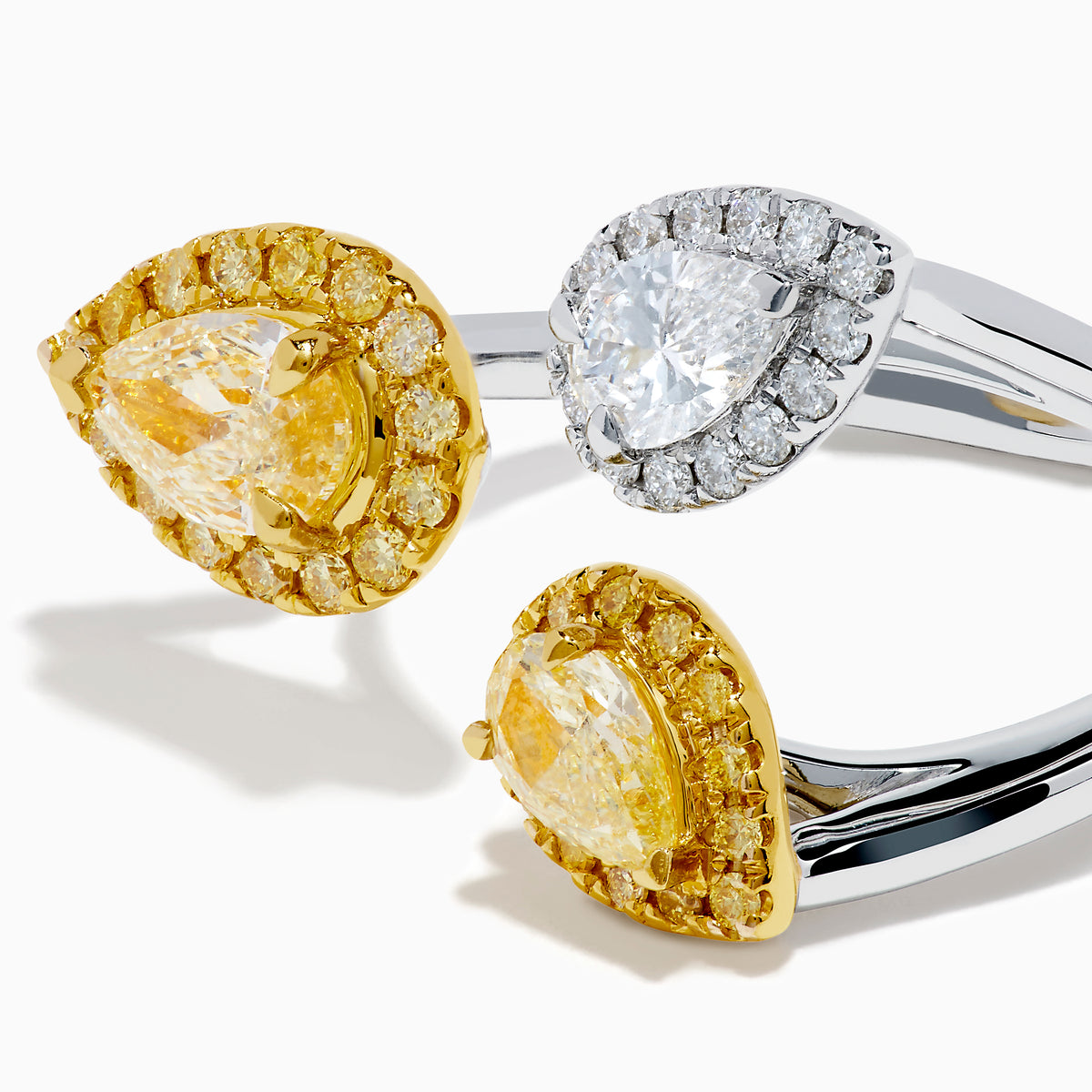 The 18K Two Tone Open Shank Yellow and White Diamond Pear Bouquet Ring features an open band with yellow gemstones bordered by smaller yellow gems and a white gemstone encircled by white diamonds.
