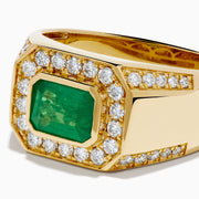 The Men's 14K Yellow Gold Emerald Signet Ring features a rectangular green emerald center, double diamond halo, and side diamonds along the band.
