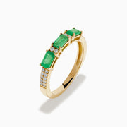 The 14K Yellow Gold Emerald and Diamond Band showcases three rectangular green emeralds set horizontally, each separated by small round diamonds, with extra diamond accents on the sides.