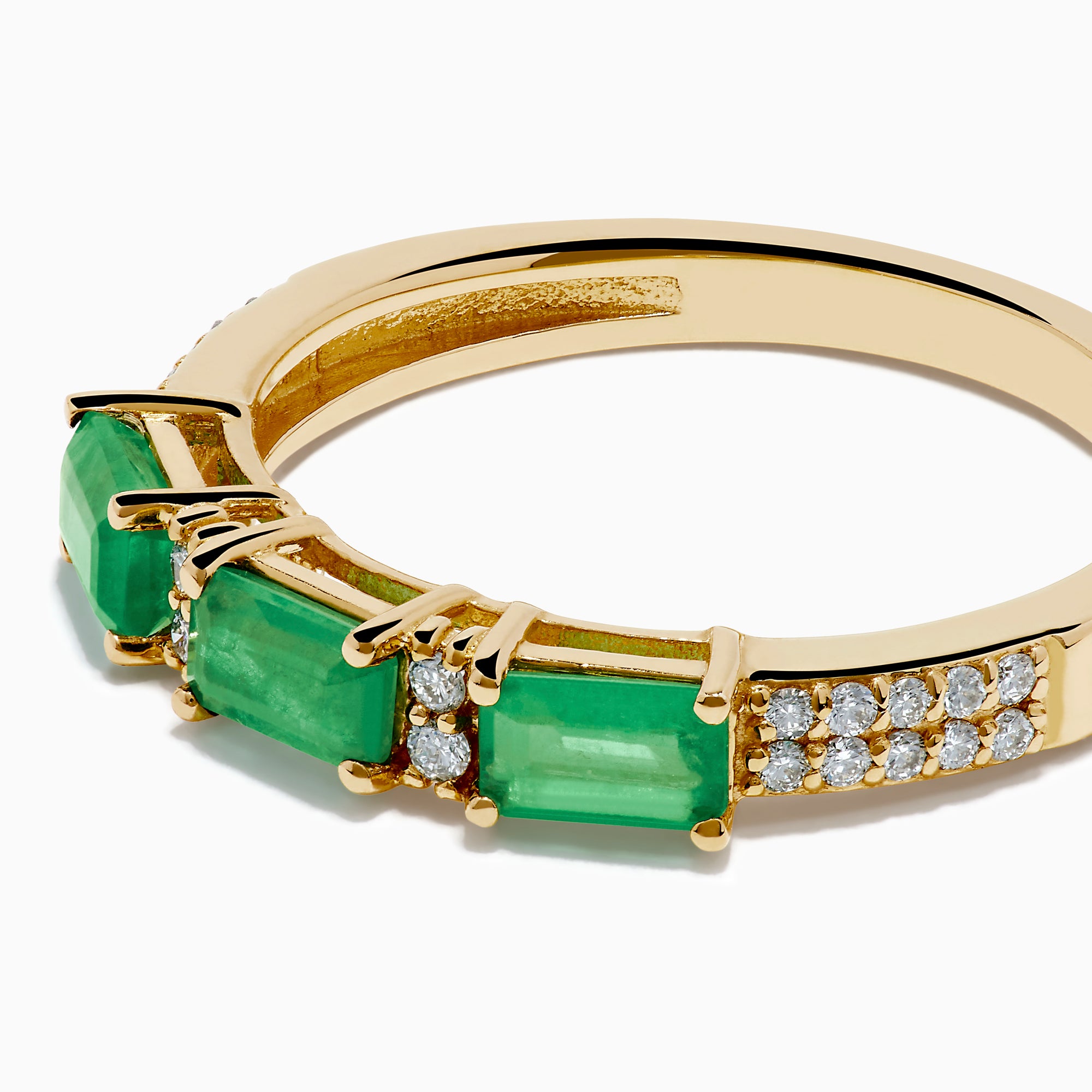 The 14K Yellow Gold Emerald and Diamond Band showcases three rectangular green emeralds set horizontally, each separated by small round diamonds, with extra diamond accents on the sides.