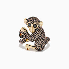 The Espresso 14K Yellow Gold and Black Diamond Monkey Ring features a whimsical monkey with exaggerated eyes and ears, encrusted with brown and black diamonds as it sits clutching its tail—an eye-catching statement piece.