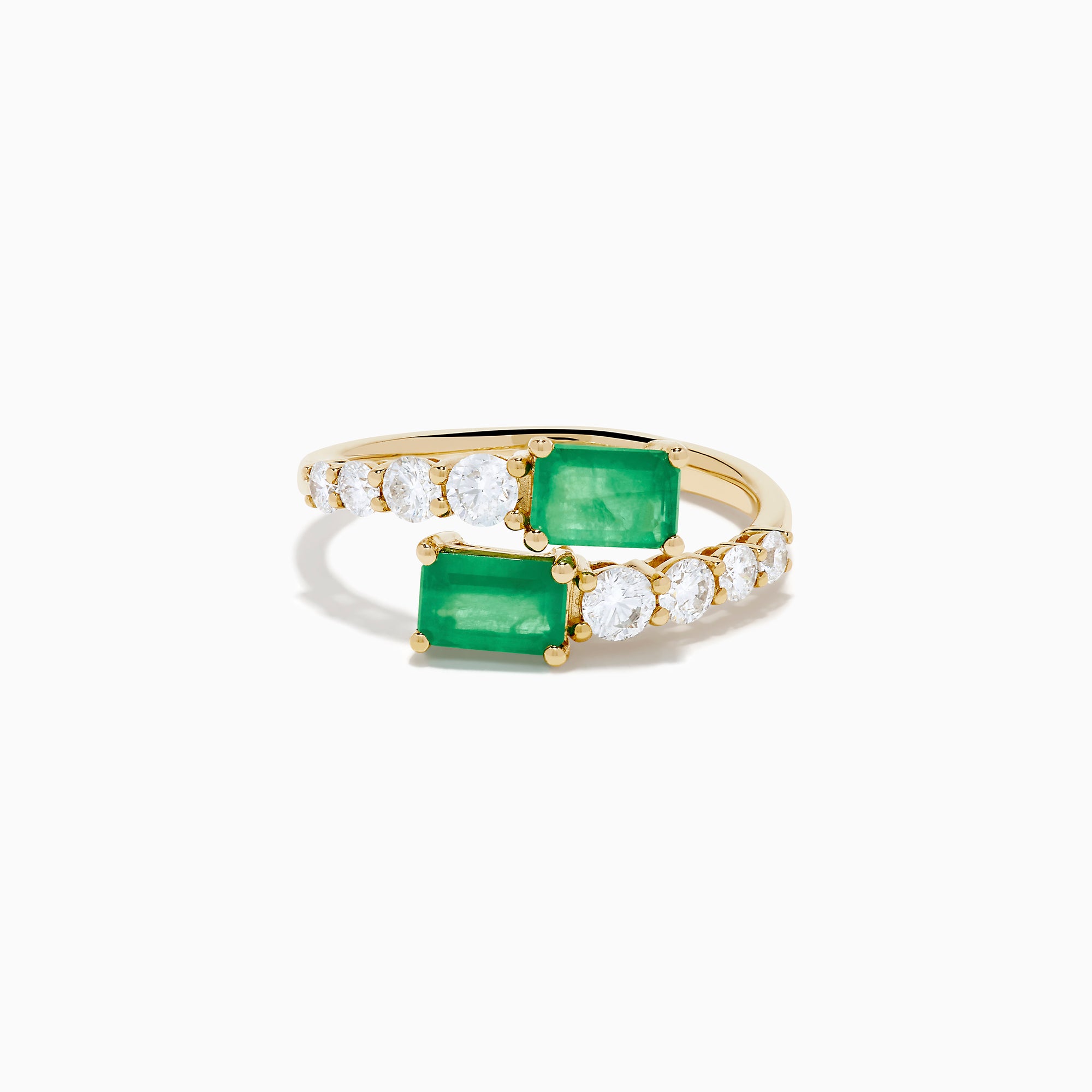 The 14K Yellow Gold Diamond and Emerald Bypass Ring features two rectangular green emeralds and rows of sparkling round white diamonds on each side in an open band design, set against a white background.