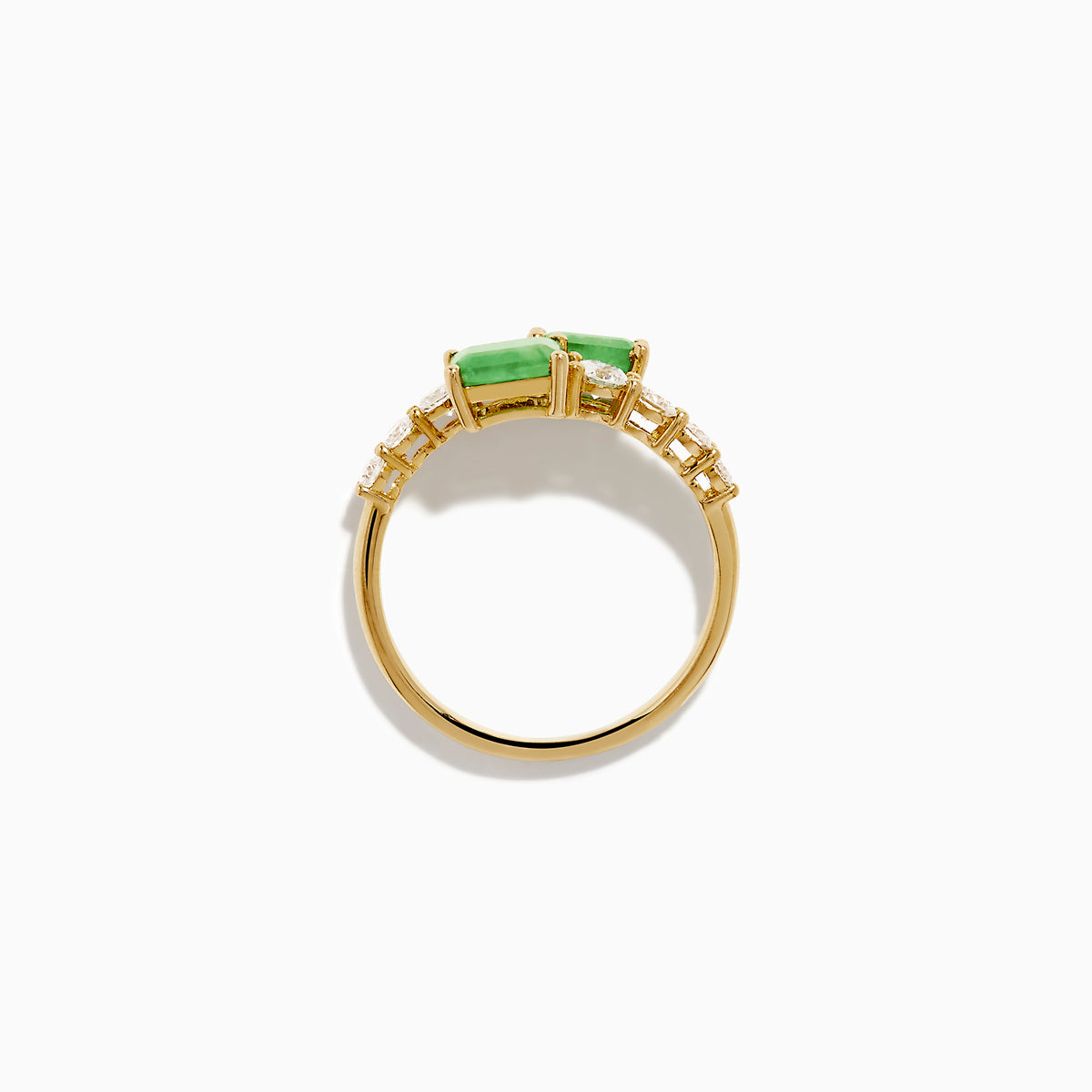 The 14K Yellow Gold Diamond and Emerald Bypass Ring features two rectangular green emeralds and rows of sparkling round white diamonds on each side in an open band design, set against a white background.
