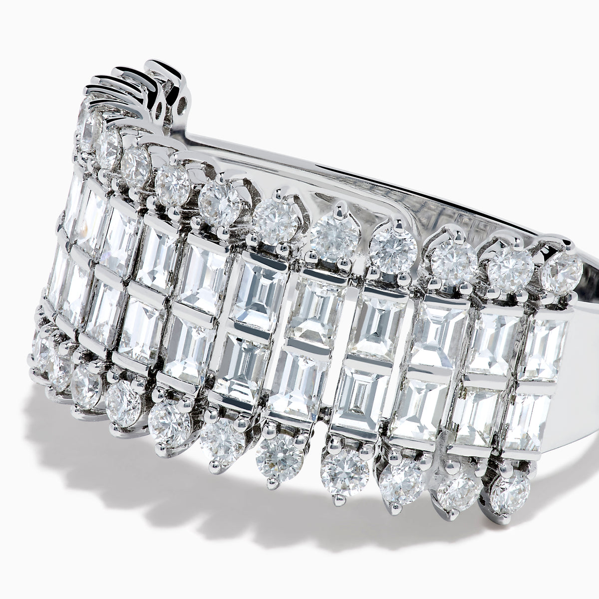 The 14K White Gold Baguette and Round Diamond Statement Ring features multiple rows of sparkling diamonds in a symmetrical, luxurious design, displayed elegantly against a white background.