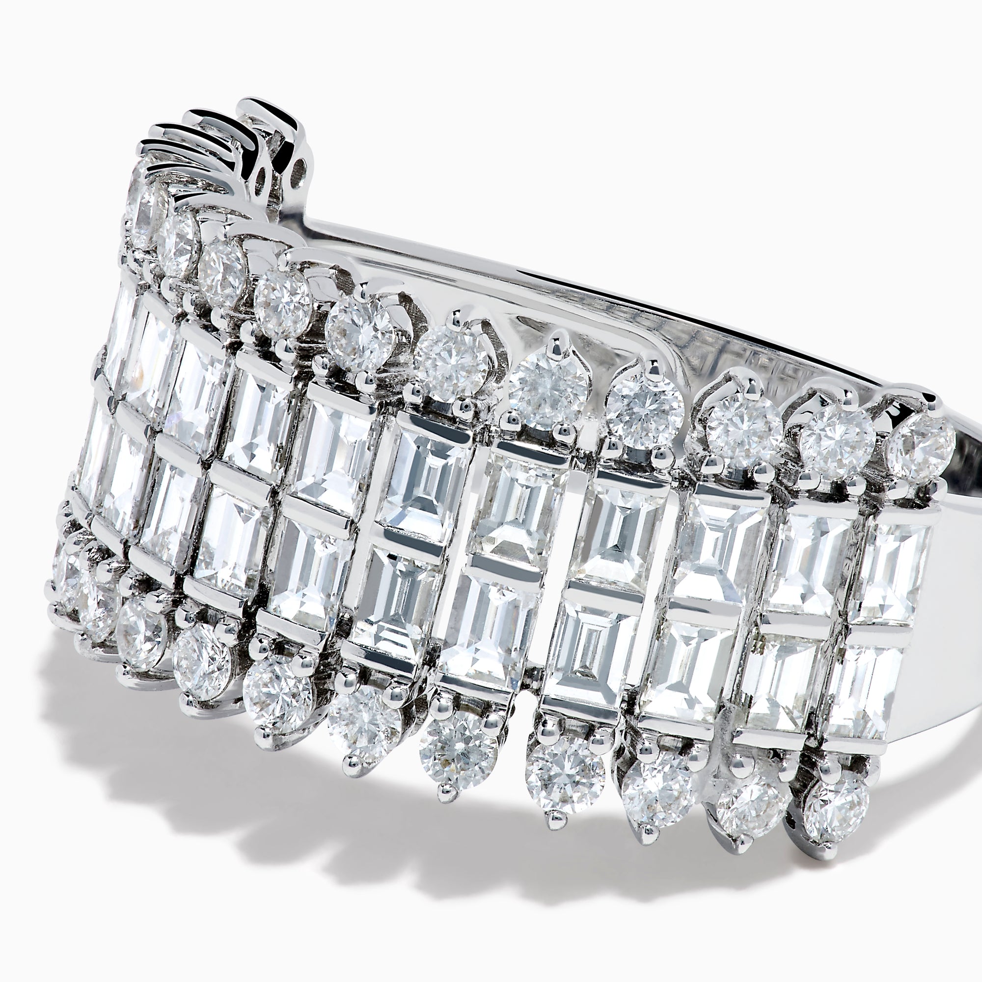 The 14K White Gold Baguette and Round Diamond Statement Ring features multiple rows of sparkling diamonds in a symmetrical, luxurious design, displayed elegantly against a white background.