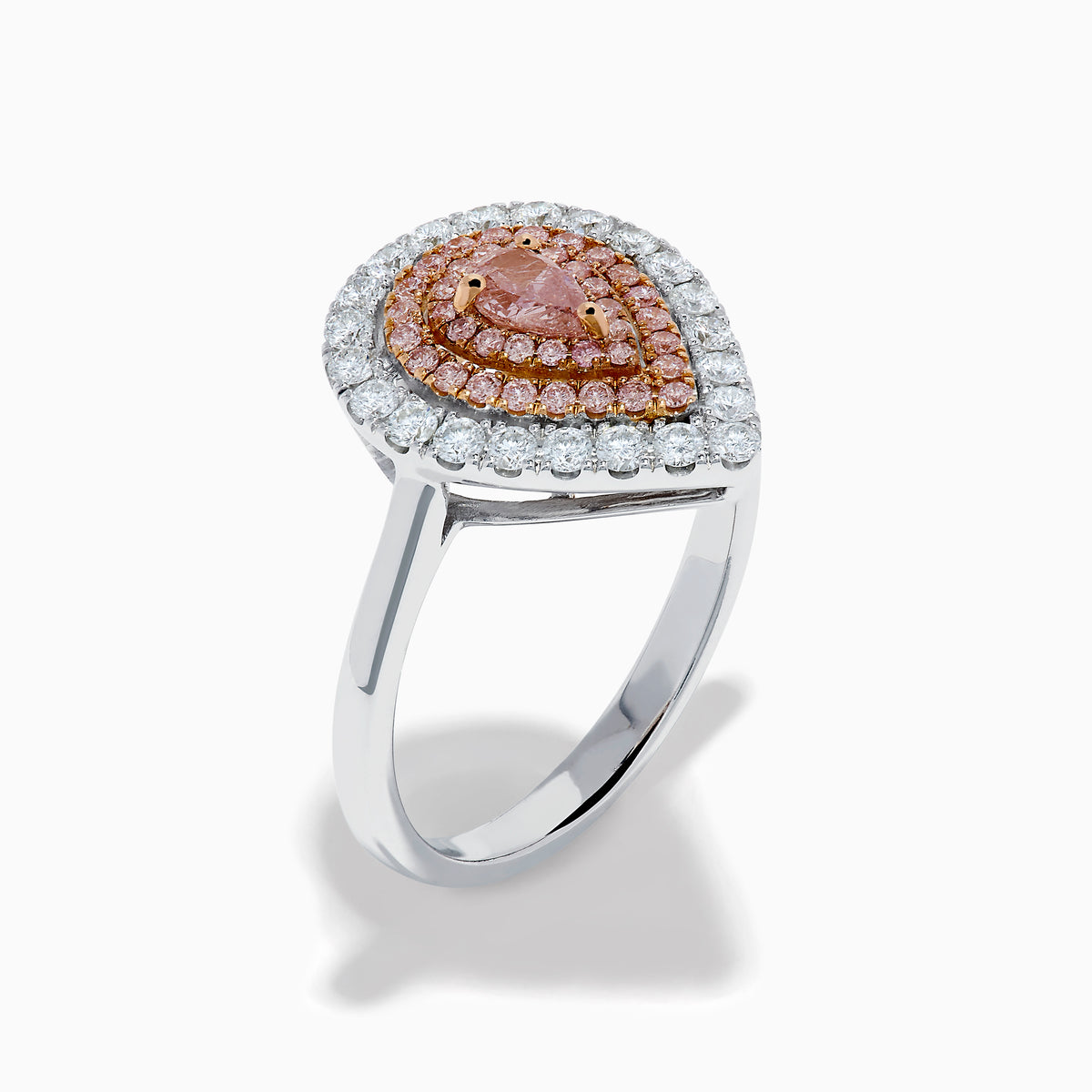 The 18K Two Tone Pear Shape Pink and White Diamond Halo Ring showcases a pear-shaped center, double halos of pink and white diamonds, and a slim two-tone band, set against a white background.