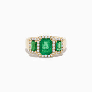 The Brasilica 14K Yellow Gold Emerald and Diamond Ring showcases a striking rectangular green emerald center, two smaller side emeralds, and a sparkling border of white diamonds.