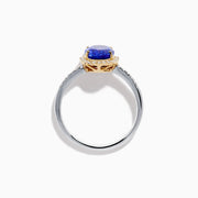 The Nahla 14K Two Tone Gold Tanzanite and Diamond Halo Ring features an oval blue tanzanite center, encircled by a diamond halo and diamond-accented band, all set in elegant two-tone 14K gold.